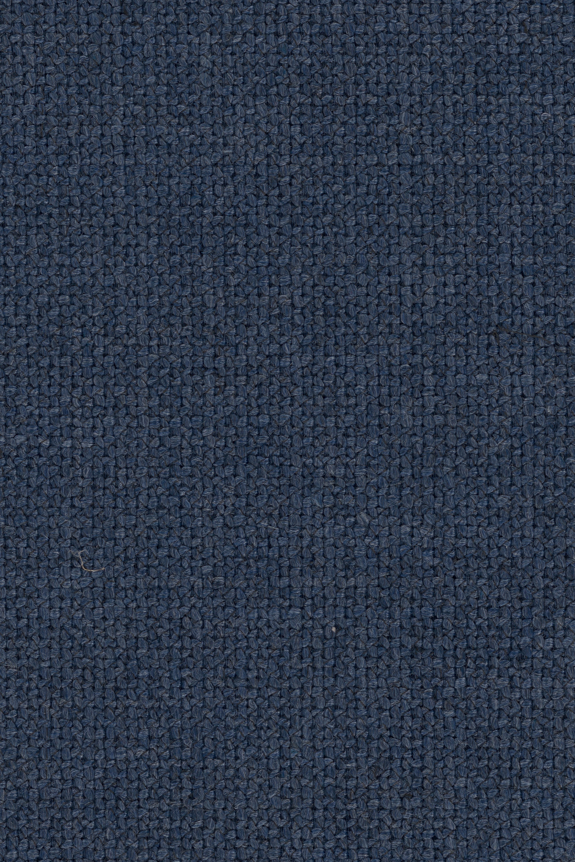 Close-up of the N701 Modular Sofa - Blue by Ethnicraft, showcasing its textured, dark blue woven fabric with a uniform, grid-like pattern. The thick and durable material makes it an excellent choice for upholstering this European modular sectional sofa.