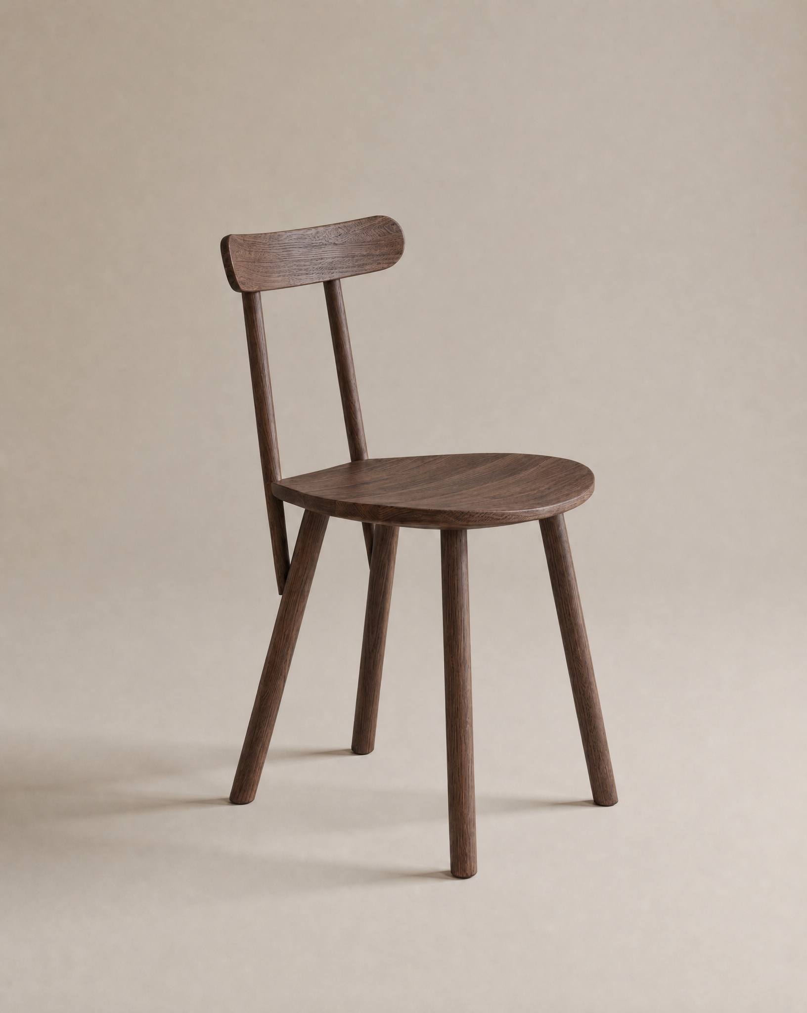 The Figura Dining Chair by Wooden Stories features an espresso oak finish, a round seat, four straight legs, and a curved backrest, shown against a plain beige background.