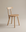 The Figura Dining Chair | Light Oak by Wooden Stories features a simple wooden design with four legs, a round seat, and a straight backrest—showcasing classic Scandinavian style against a light background.