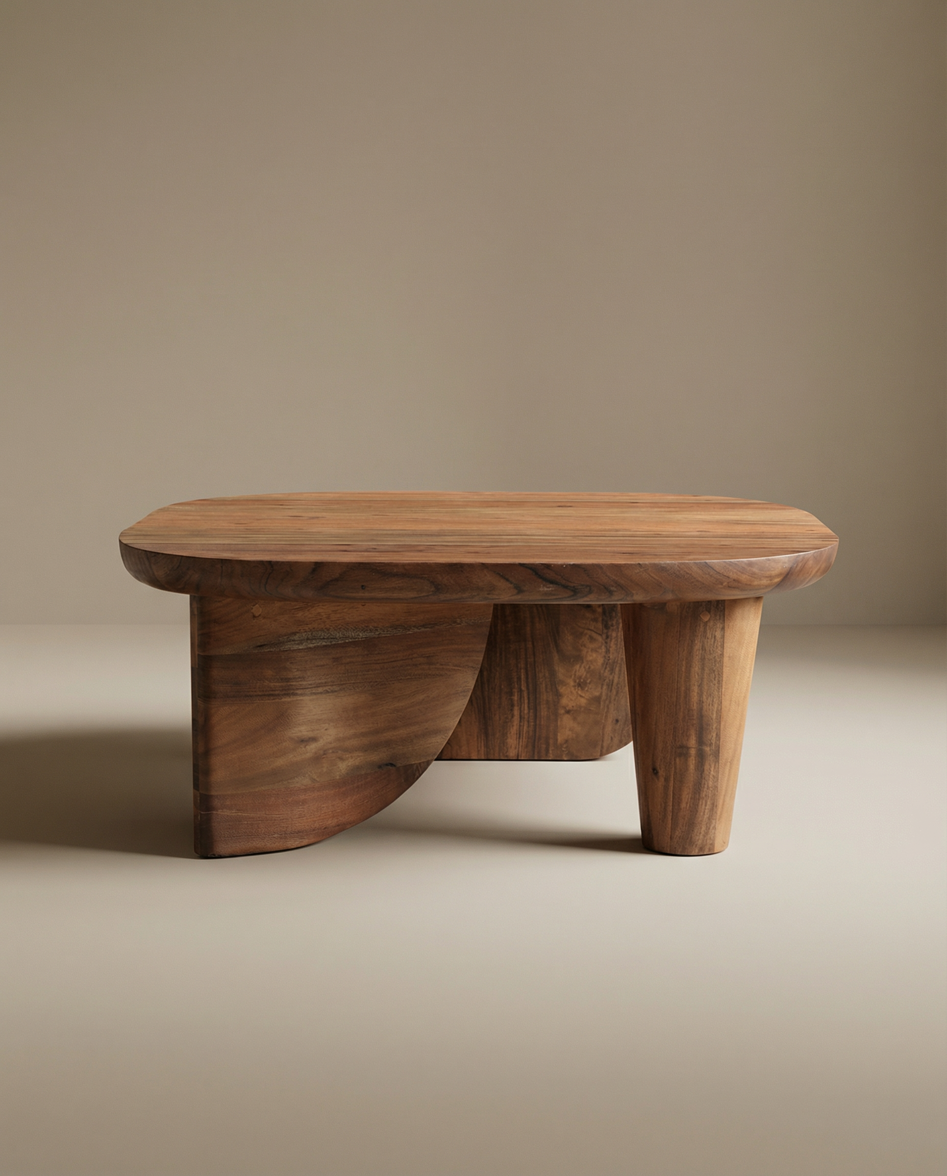 The SOBU Nick Coffee Table features a handcrafted oval top and sculptural base made from solid Acacia wood, set against a neutral background.