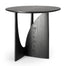The Geometric Side Table - Black Oak by Ethnicraft features a round top and intersecting sculptural base with curved and straight edges, shown here against a white background.