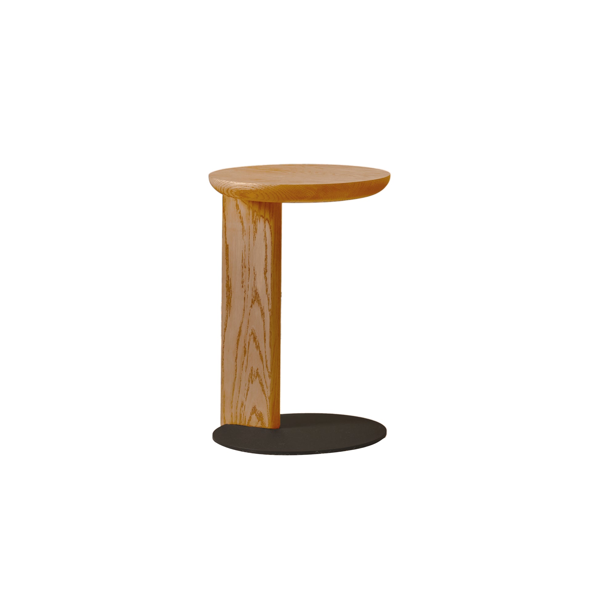 The Guild Side Table | Light Oak by Wooden Stories features a modern, minimalist timber design with a round wooden top and vertical support on an oval black metal base—ideal as a contract-grade laptop table against a white background.