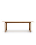 The Hover Dining Table | Light Oak by Wooden Stories features a minimalist Scandinavian design with a rectangular solid oak top and simple box-style legs, shown against a white background.