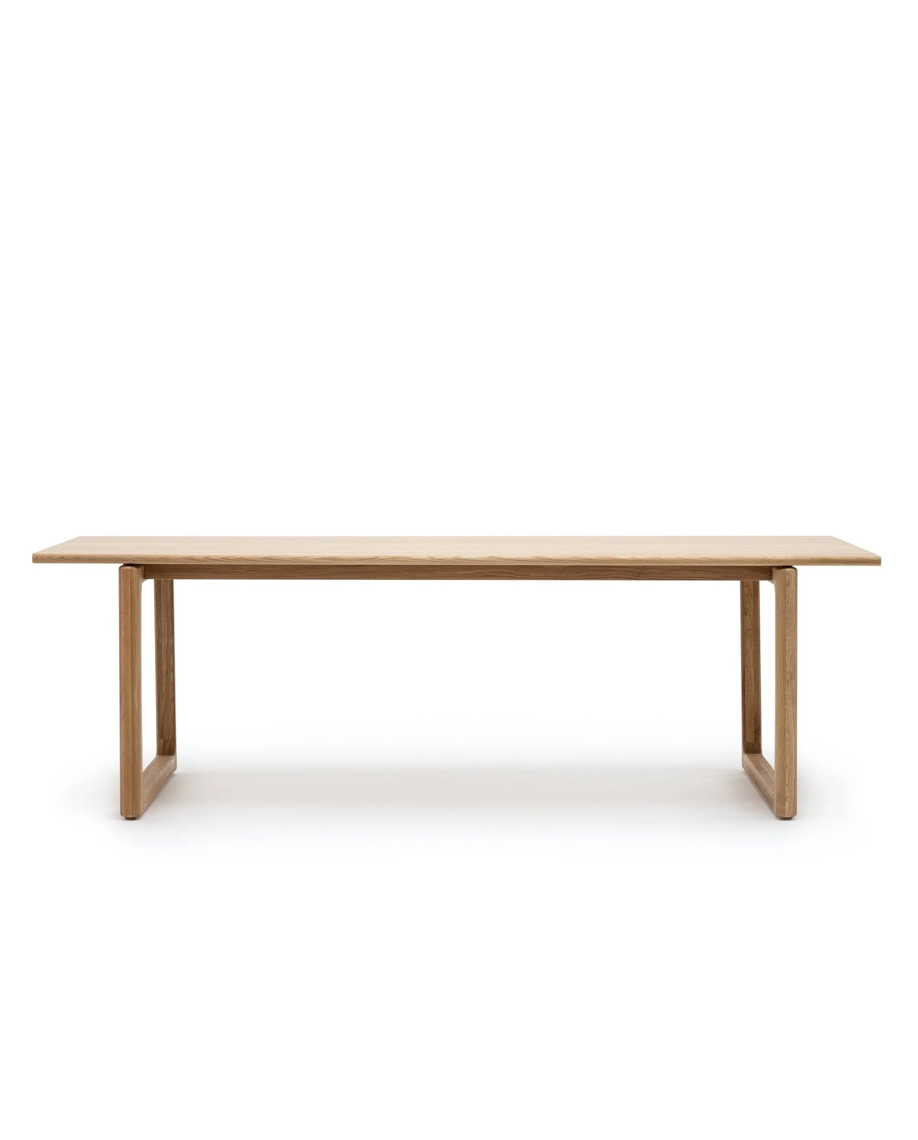 The Hover Dining Table | Light Oak by Wooden Stories features a minimalist Scandinavian design with a rectangular solid oak top and simple box-style legs, shown against a white background.