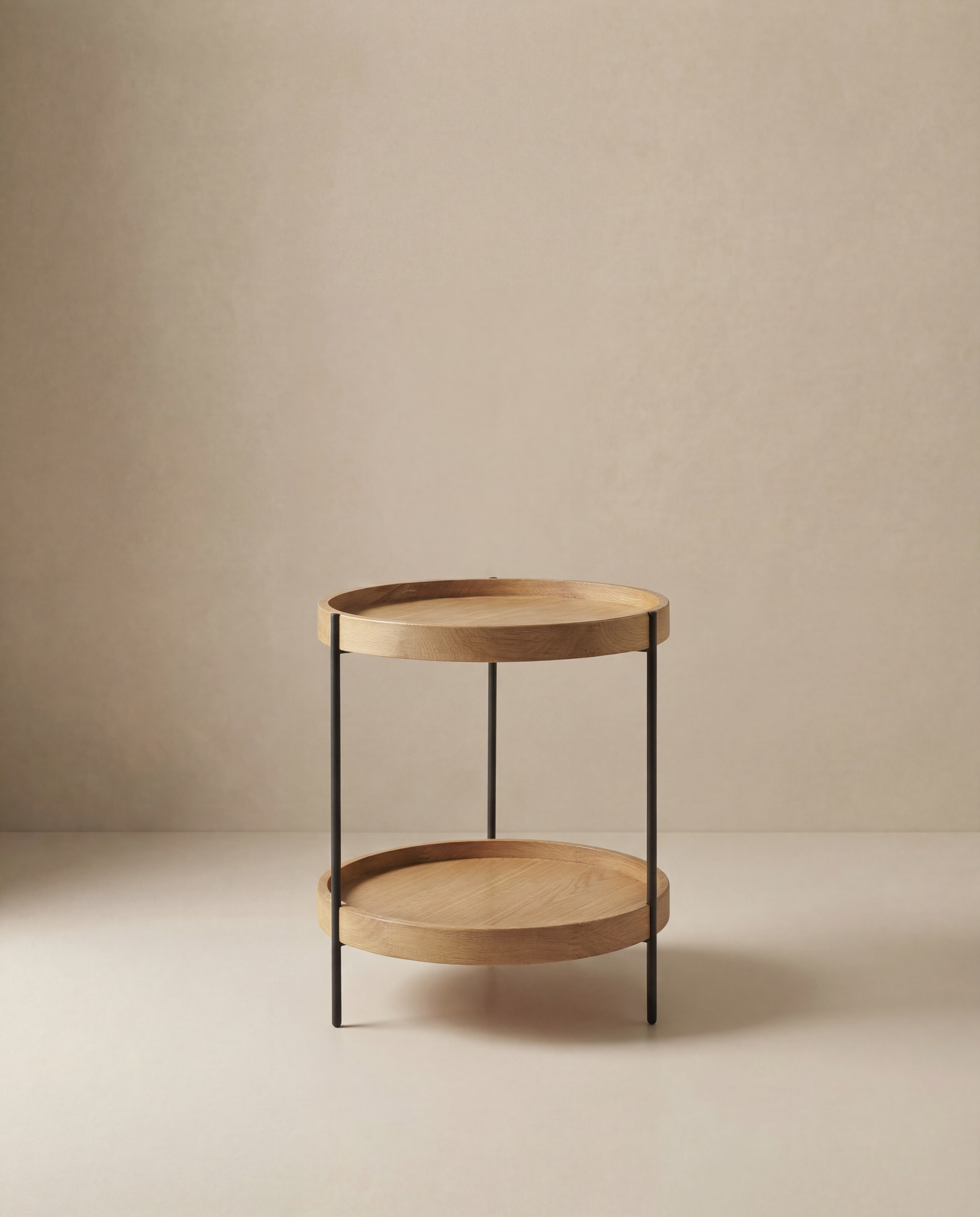 The Humla End Table by Wooden Stories features two wooden tiers and slender black metal legs, inspired by Danish design, shown against a neutral beige background.