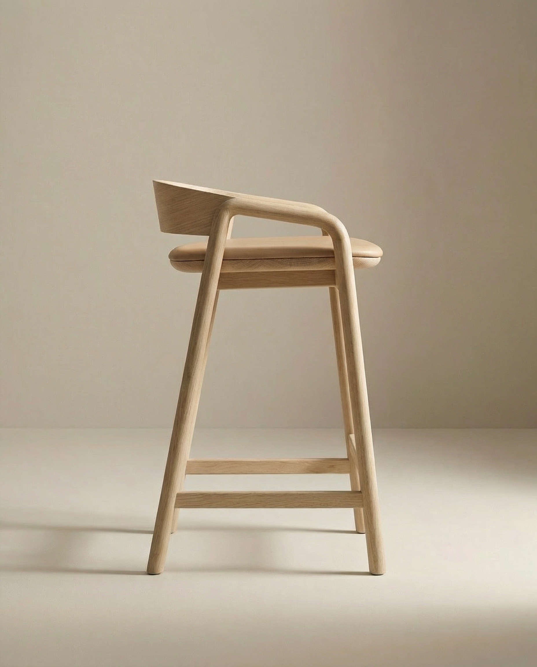 The Inlay Counter Stool by Wooden Stories features a curved leather seat and backrest, minimalist design, and light wood finish that reflects European craftsmanship—shown in profile against a neutral beige background.