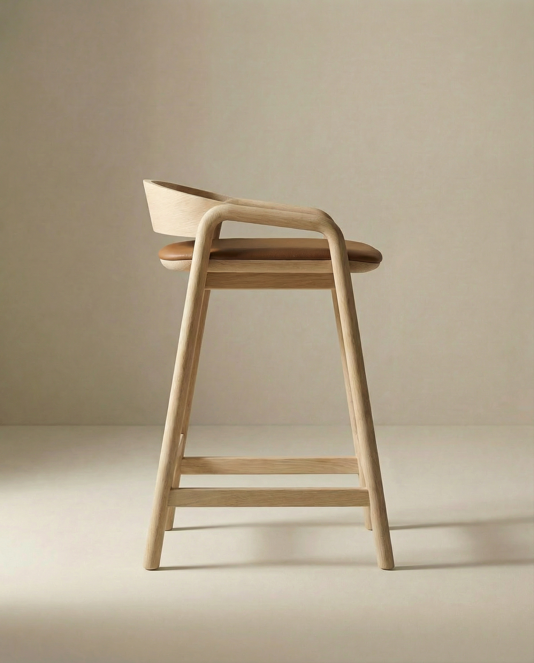 The Inlay Counter Stool | Leather Seat by Wooden Stories features a solid oak frame, curved backrest, and tan leather seat, shown against a neutral beige background.