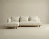 The Islet Modular Sofa | Fabric • M3 by Wooden Stories is a modern, minimalist beige sectional with three seat and back cushions plus a left-side chaise, set against a matching beige background.