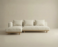 The Islet Modular Sofa | Fabric • M3 by Wooden Stories is a modern, minimalist beige sectional with three seat and back cushions plus a left-side chaise, set against a matching beige background.