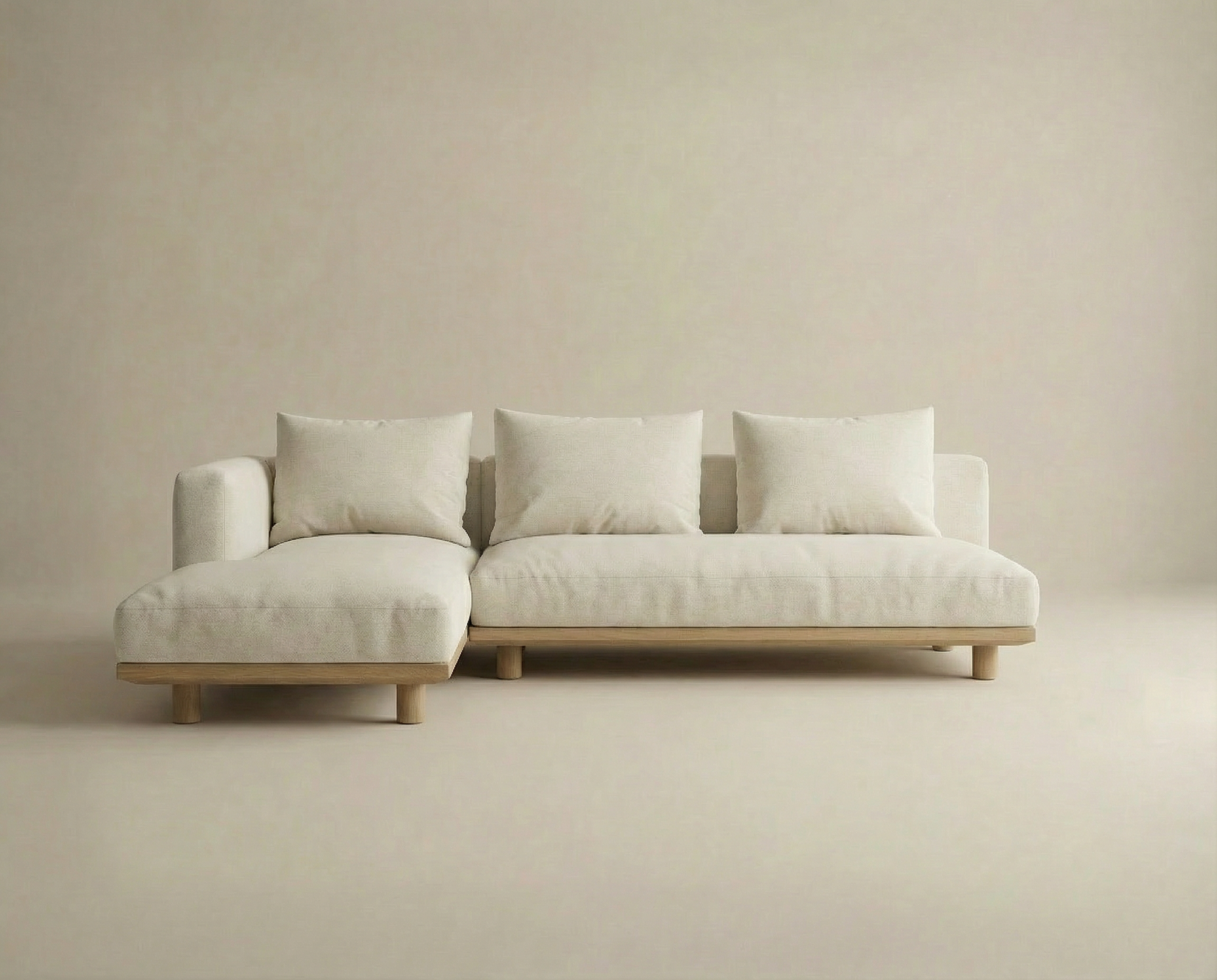 The Islet Modular Sofa | Fabric • M3 by Wooden Stories is a modern, minimalist beige sectional with three seat and back cushions plus a left-side chaise, set against a matching beige background.