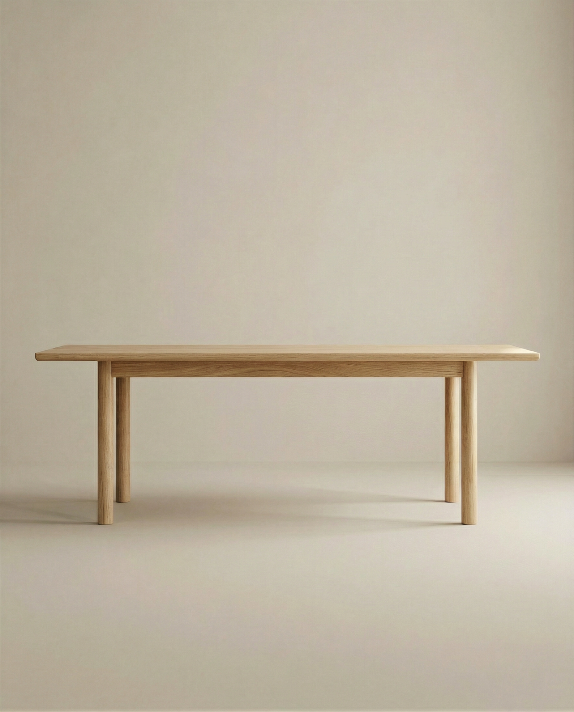 The Itamae Dining Table in Light Oak by Wooden Stories features a smooth rectangular top, four cylindrical legs, and minimalist Scandinavian design, set against a plain light beige background. Contract grade craftsmanship ensures durability.