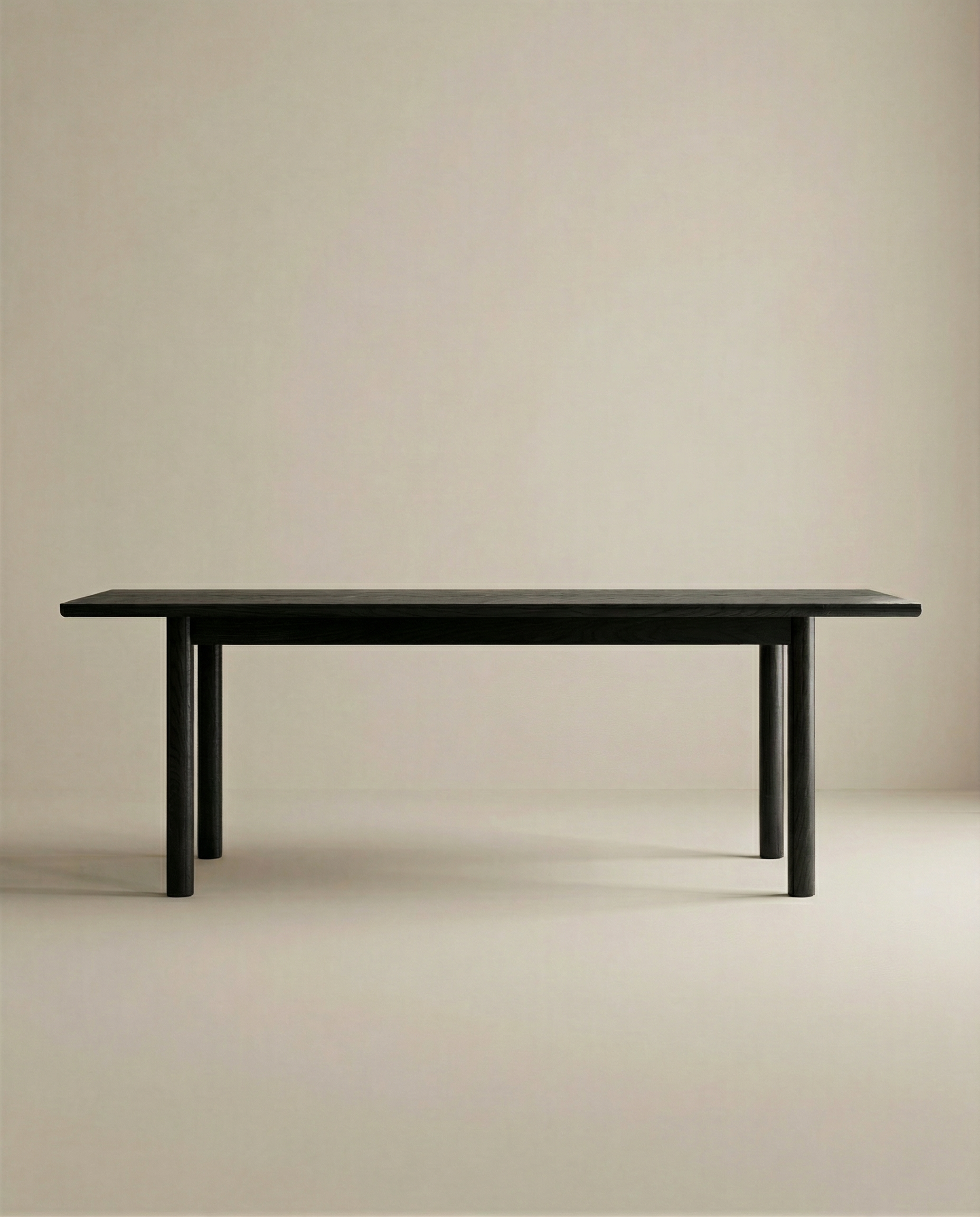 The Wooden Stories Itamae Dining Table in Black Oak features a minimalist, rectangular design with four legs and Scandinavian style, displayed against a light beige background.