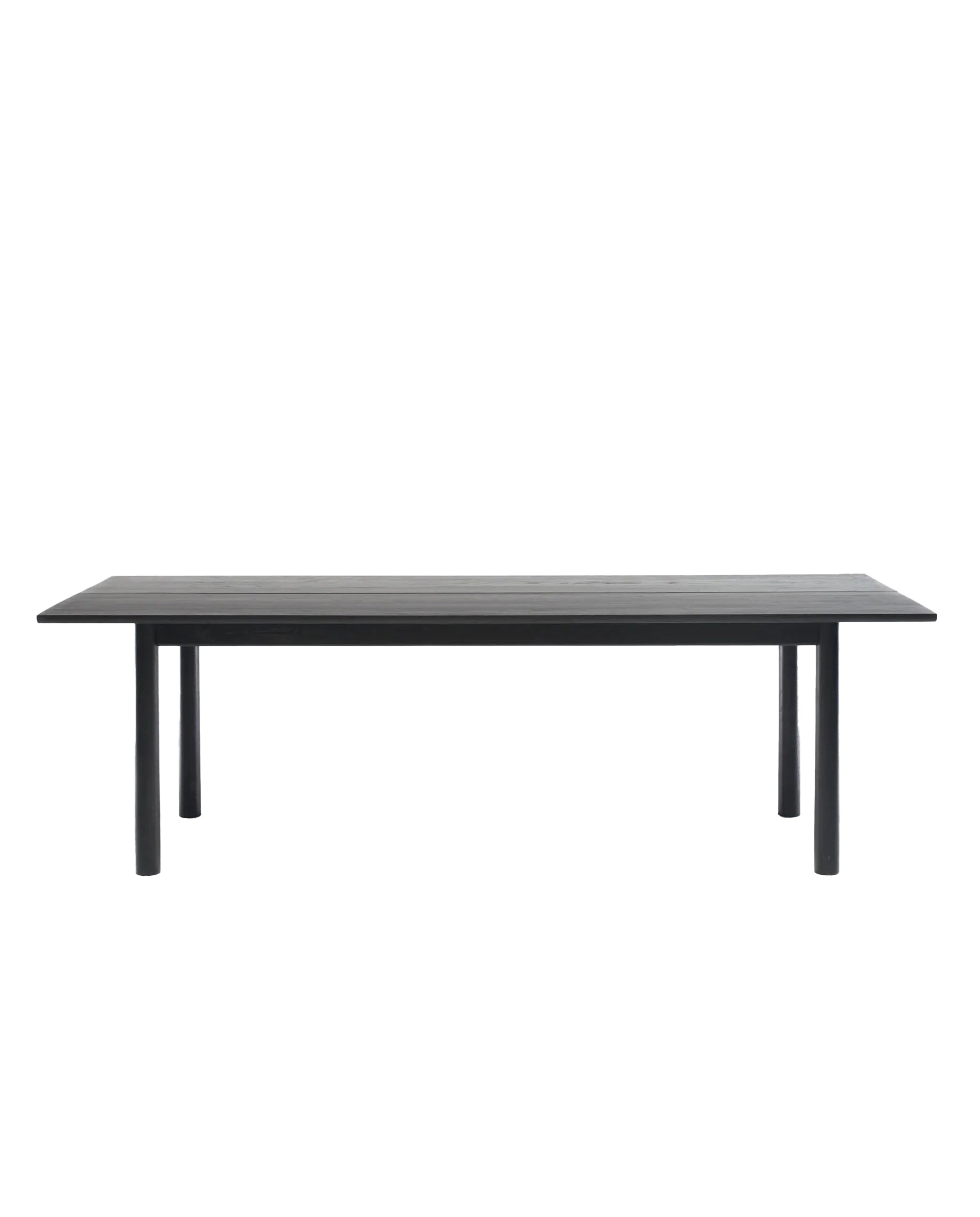 The Wooden Stories Itamae Dining Table | Black Oak features a minimalist Scandinavian design with a flat rectangular top and four round legs, crafted to contract-grade standards, shown against a plain white background.