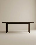 The Wooden Stories Itamae Dining Table in Espresso Oak features a minimalist Scandinavian design with four sturdy legs, crafted from solid oak, and is displayed against a plain light beige background.