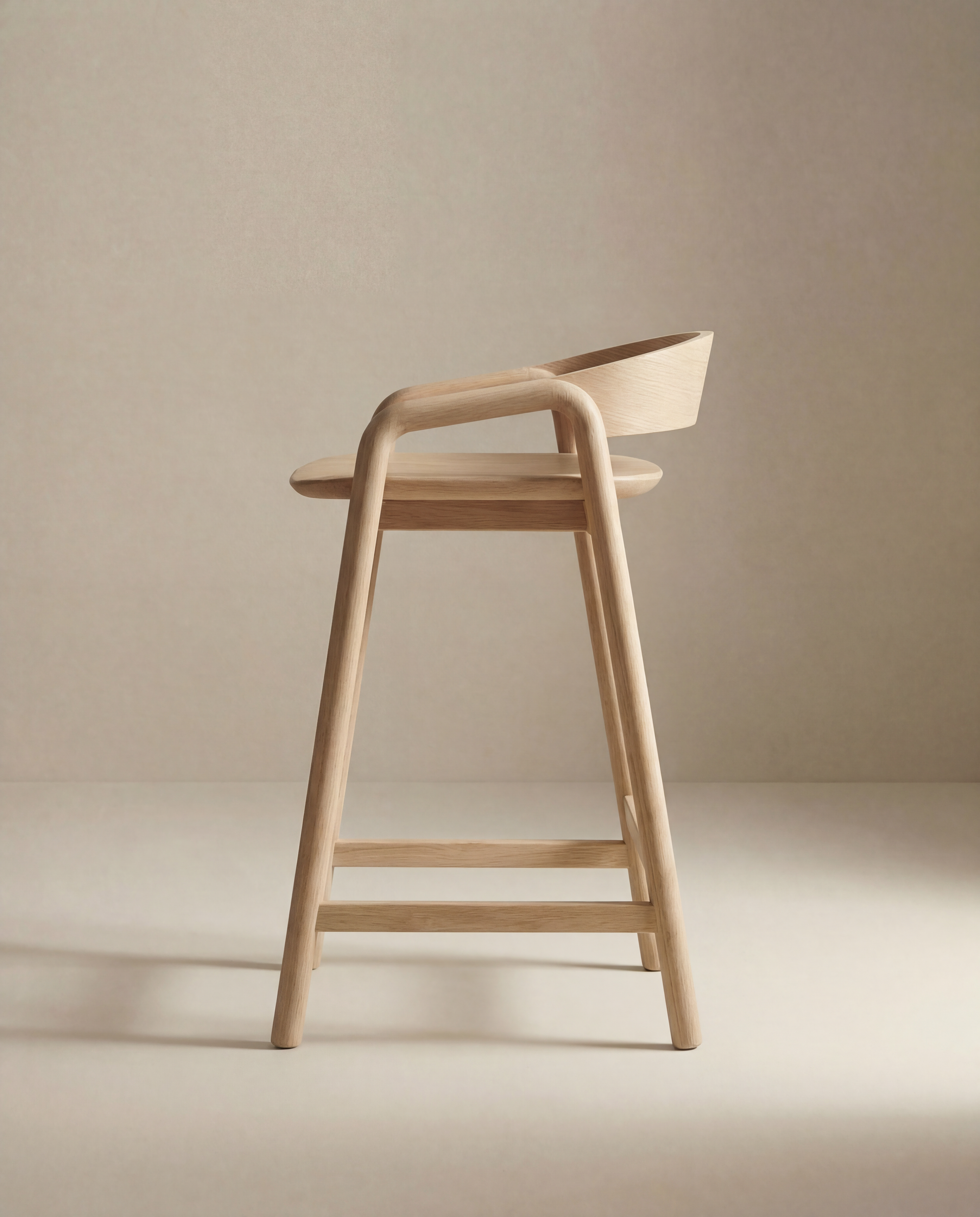 The Inlay Counter Stool | Wood Seat by Wooden Stories features a minimalist solid oak design with a curved backrest, ideal for Danish counter or kitchen island seating, shown against a plain beige background.