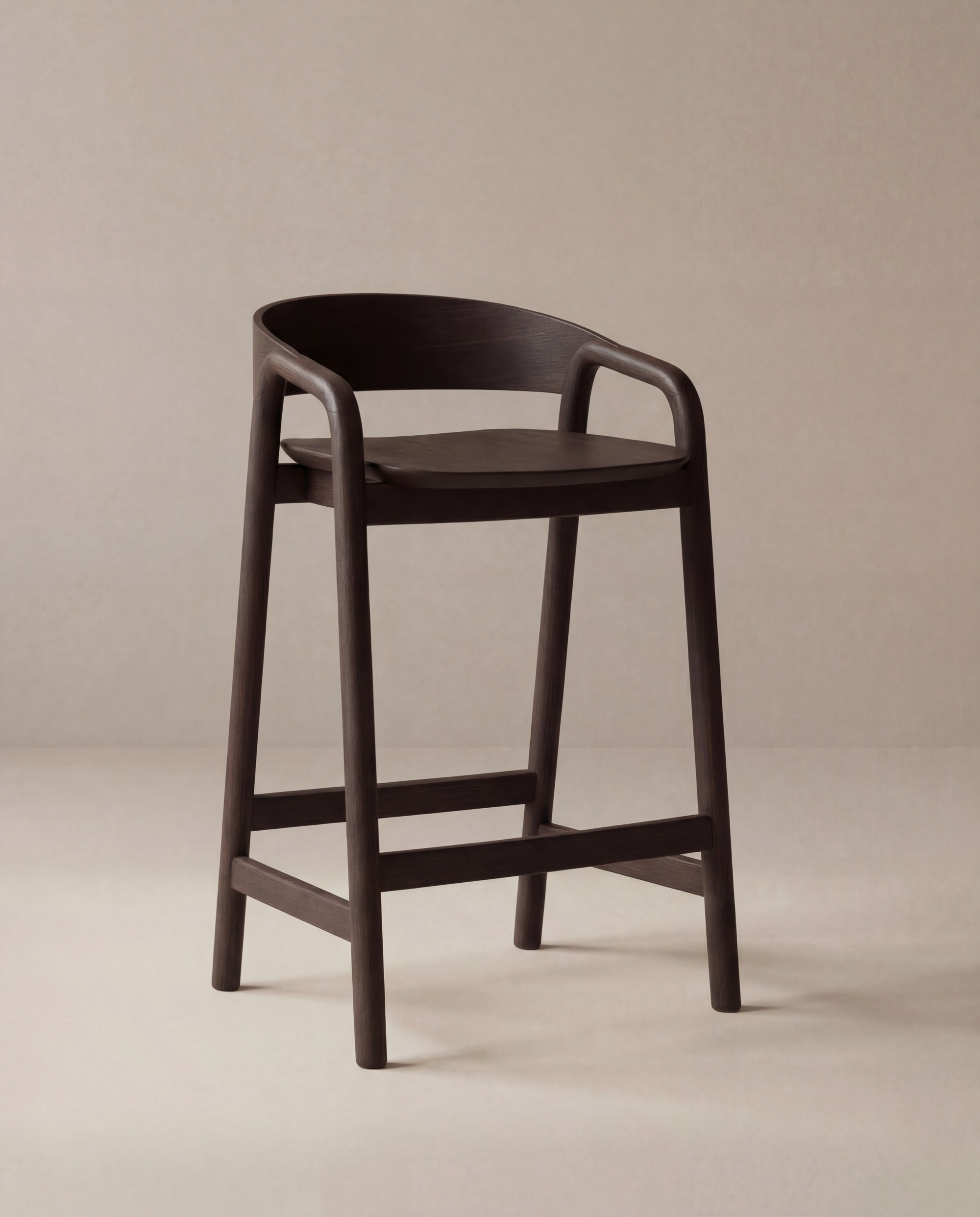 The Inlay Counter Stool | Wood Seat by Wooden Stories is a modern Danish counter stool in solid oak with a curved backrest and armrests. Ideal for kitchen island seating, this dark wooden piece has four legs with horizontal supports, shown on a beige background.