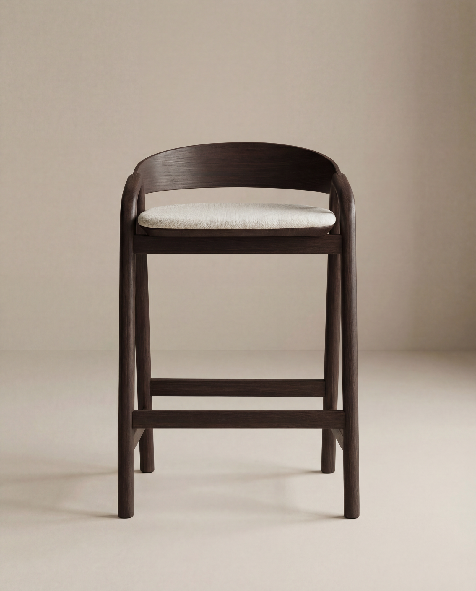 The Inlay Counter Stool | Fabric Seat by Wooden Stories features a modern solid oak frame, curved backrest, and light cushioned seat, presented against a neutral beige background.