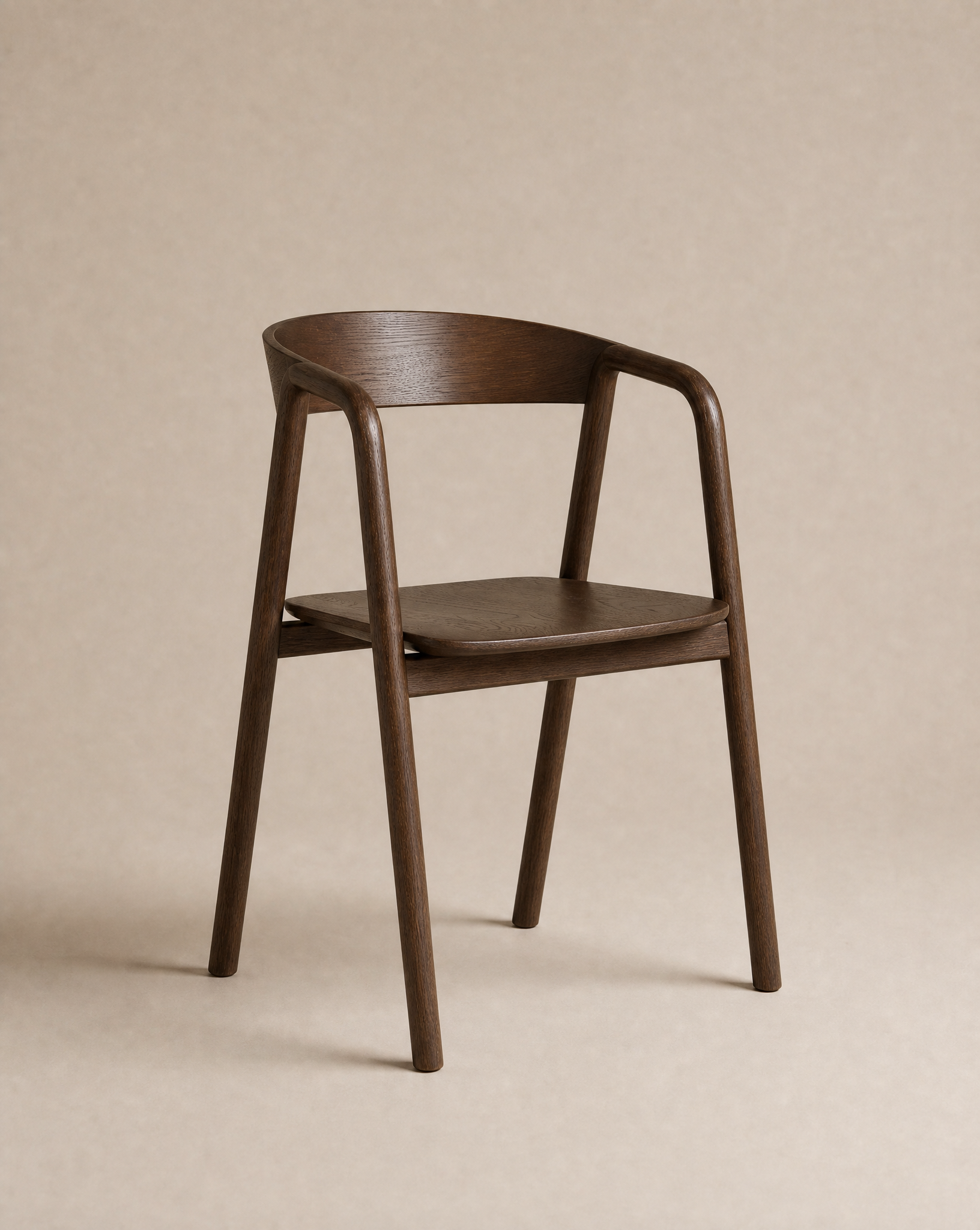 The Inlay Dining Chair | Wood from Wooden Stories, crafted in solid oak with a curved backrest and armrests, showcases clean lines and a smooth dark brown finish as it sits against a neutral beige background.