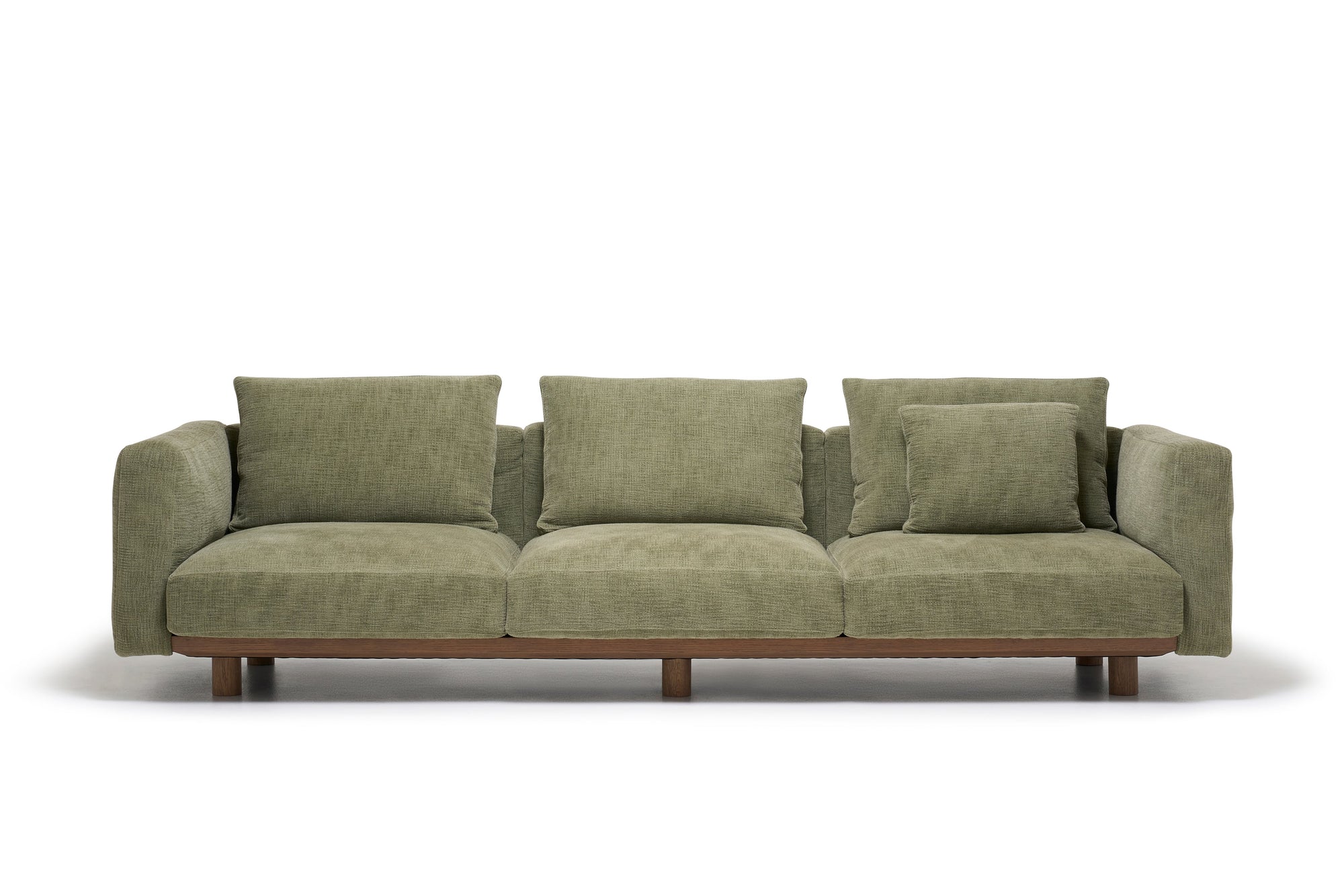 The Islet Sofa | Fabric by Wooden Stories is a modern olive green sofa with three seat cushions, four matching backrest cushions, and a wooden base, displayed against a plain white background.