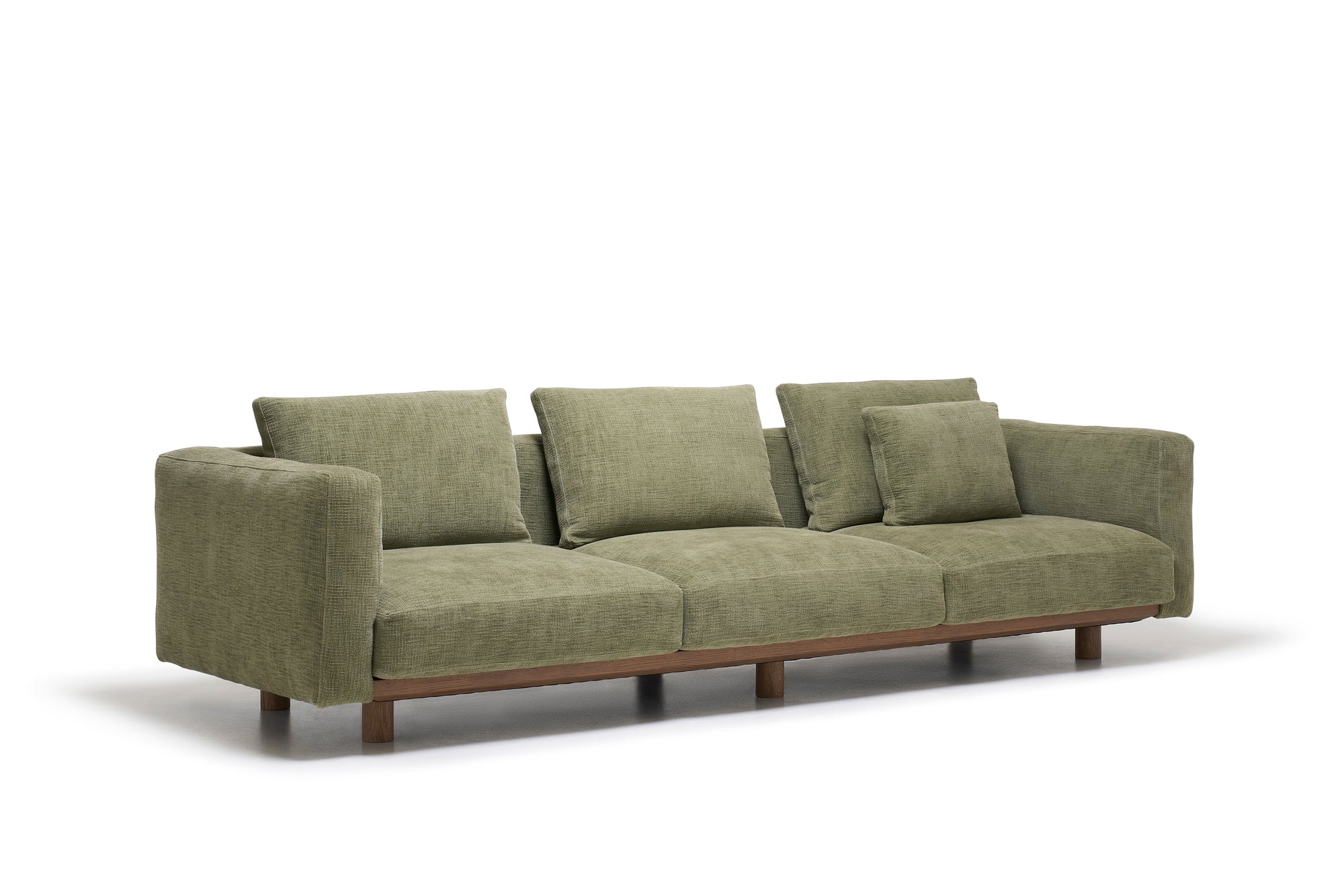 The Islet Sofa | Fabric by Wooden Stories is a modern olive green sofa featuring three seat cushions, four backrest pillows, wide armrests, and a wooden base, shown against a white background.