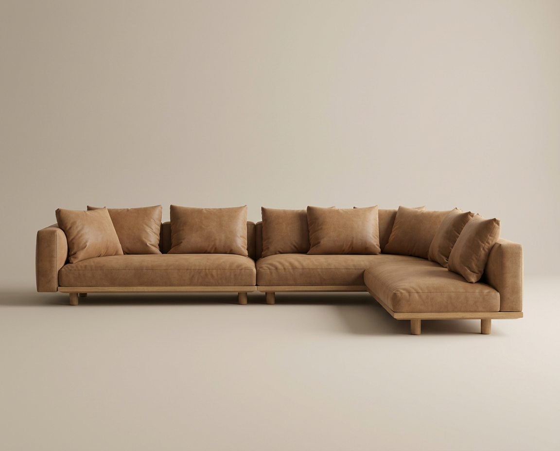 The Islet Modular Sofa | Leather • M2 by Wooden Stories is an L-shaped sectional in light brown leather with matching cushions and wooden legs, shown against a plain beige background.