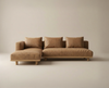 The Islet Modular Sofa | Leather • M3 by Wooden Stories, an L-shaped sectional with light brown upholstery and matching cushions, sits on a light beige floor against a neutral wall.