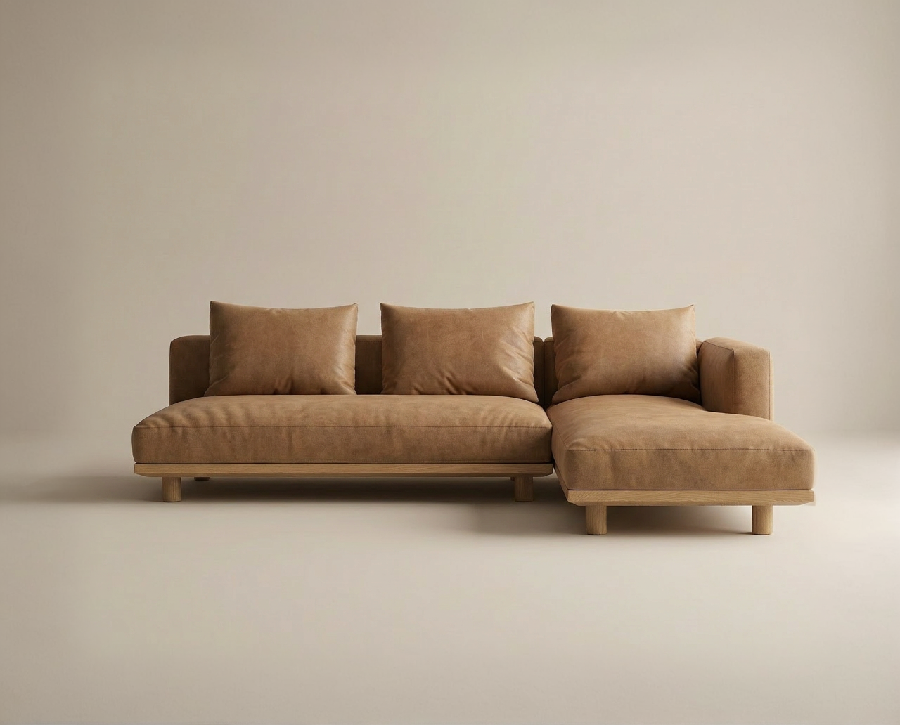 The Islet Modular Sofa | Leather • M3 by Wooden Stories is a modern, minimalist brown sectional with three seat and back cushions, plus a right-side chaise, displayed against a plain beige background.