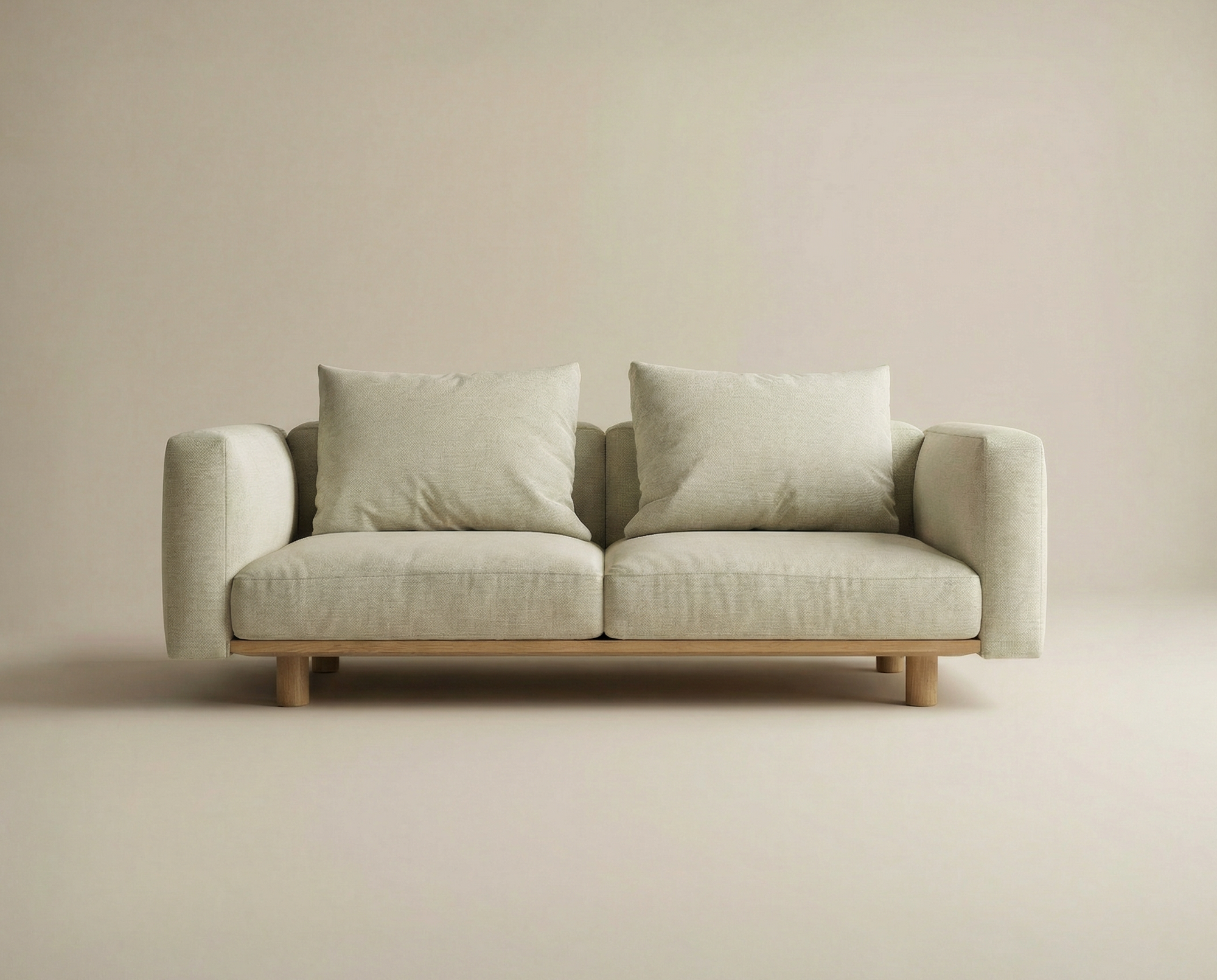 The Islet Sofa | Fabric by Wooden Stories is a modern, minimalist beige sofa with customizable upholstery, two large seat and back cushions, and rests on a solid oak platform with wooden armrests.