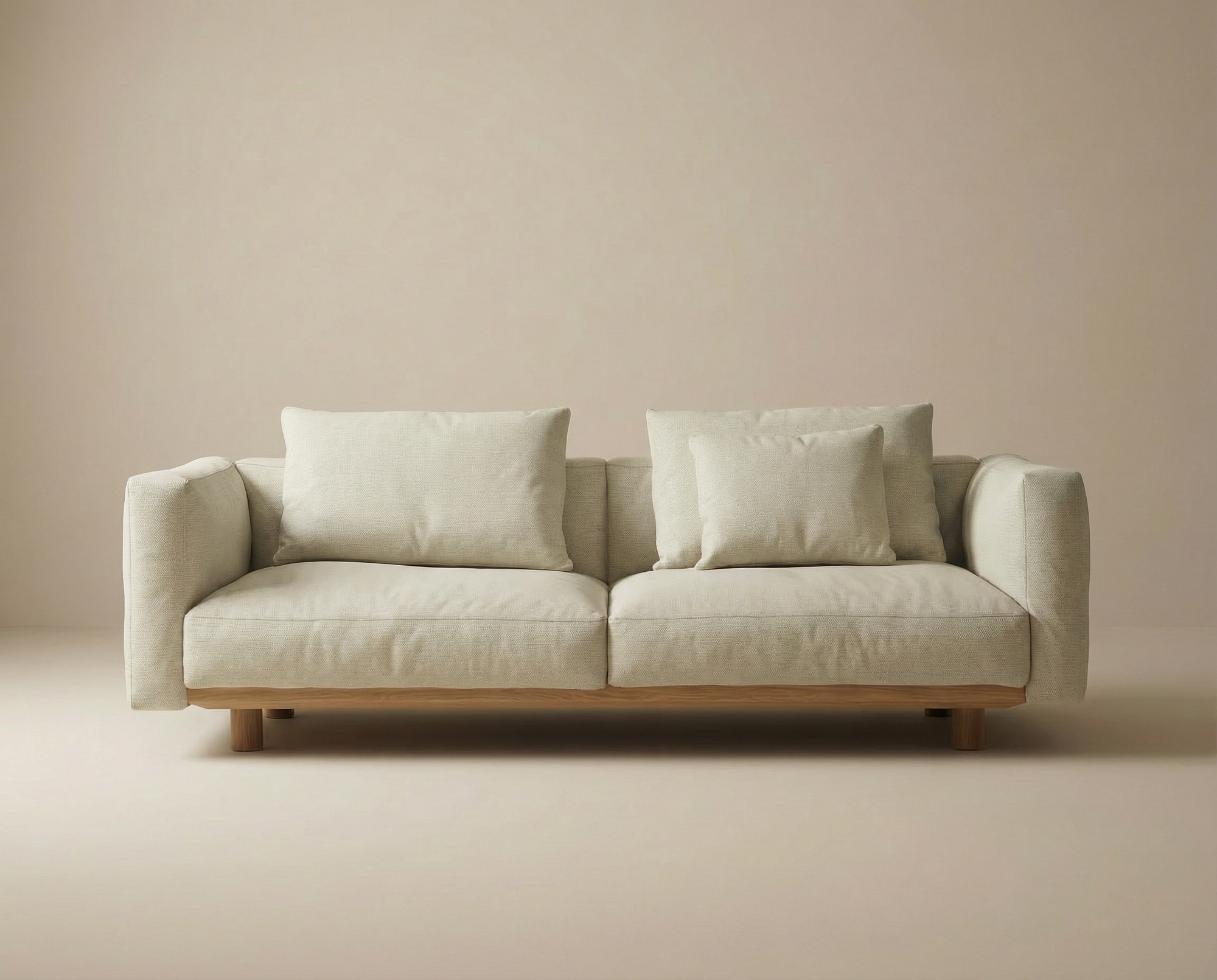 The Islet Sofa | Fabric by Wooden Stories, featuring customizable upholstery and wooden legs, brings a modern, minimalist touch to neutral interiors with its beige modular design.