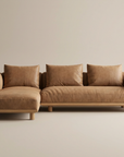 The Islet Modular Sofa | Leather • M1 by Wooden Stories is a modern light brown leather sectional with three seat cushions, three back pillows, and a left-side chaise, shown against a beige background.