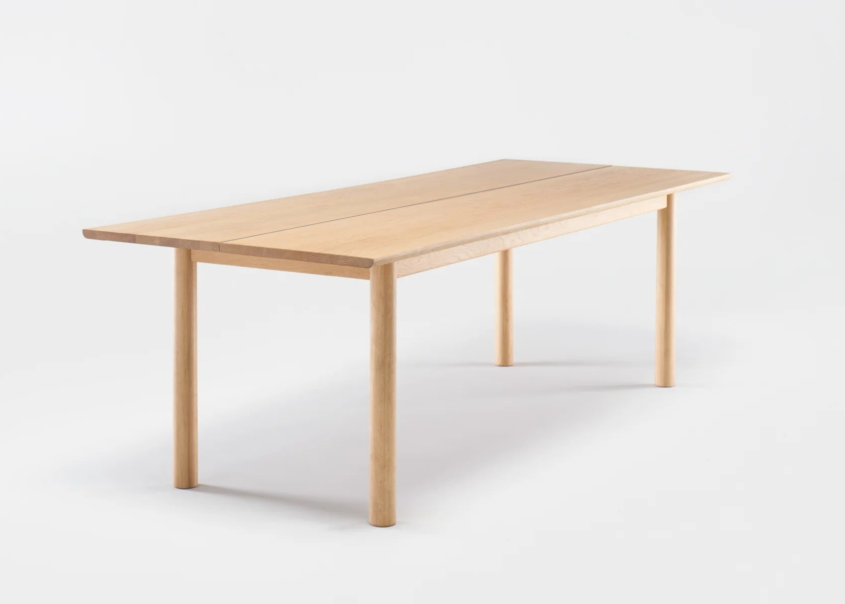 The Itamae Dining Table by Wooden Stories features a simple, rectangular solid oak design with four straight legs and a smooth light oak finish in classic Scandinavian style, shown against a plain white background.