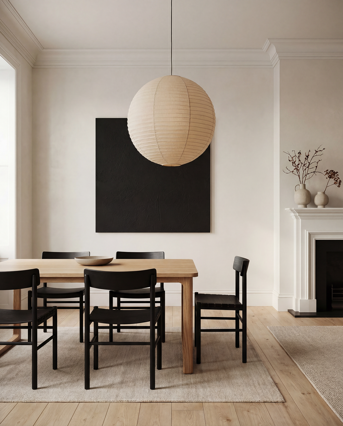 Minimalist dining room with a wooden table, six black chairs, and the Jakarta Linen Pendant - Off-White by FAIRE/LUMIERE SHADES. Simple decor and neutral tones paired with natural light create a calm, inviting space.
