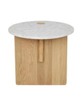 The Pivot Side Table | Light Oak by Wooden Stories is a small round table with a white marble top, solid light oak base, Danish design, and a distinctive center hole.