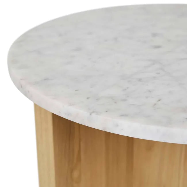 The Pivot Side Table | Light Oak by Wooden Stories features a round white marble top with subtle grey veining, resting on a light solid wood cylindrical base, inspired by Danish design with only the table edge and upper base visible.