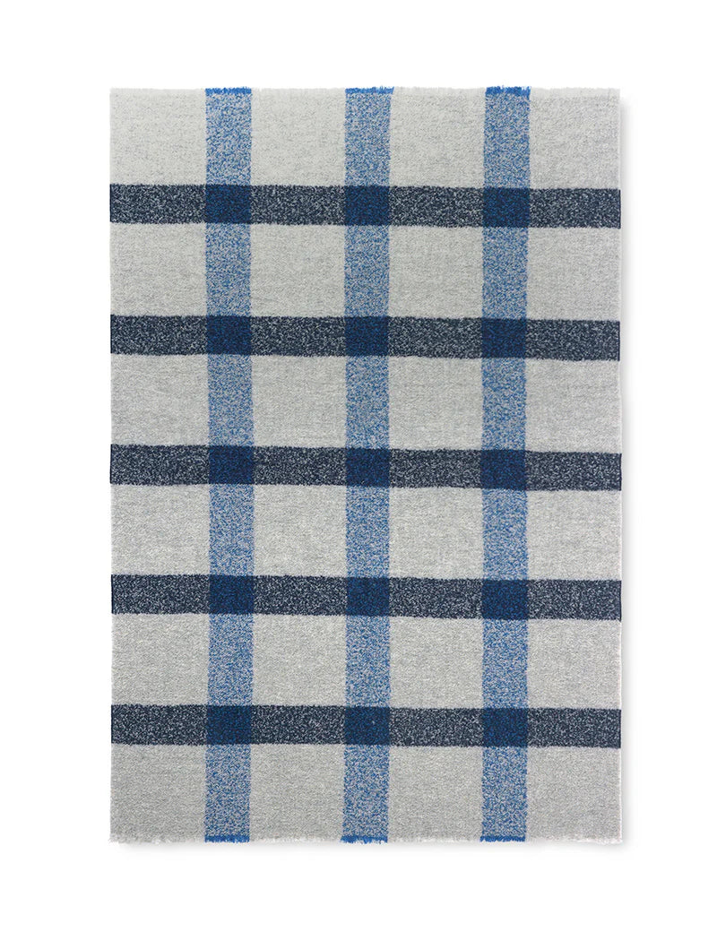 The Lava Throw - Cobalt Blue by Elvang Denmark features a gray base with intersecting blue plaid lines in varying shades, inspired by Scandinavian design.