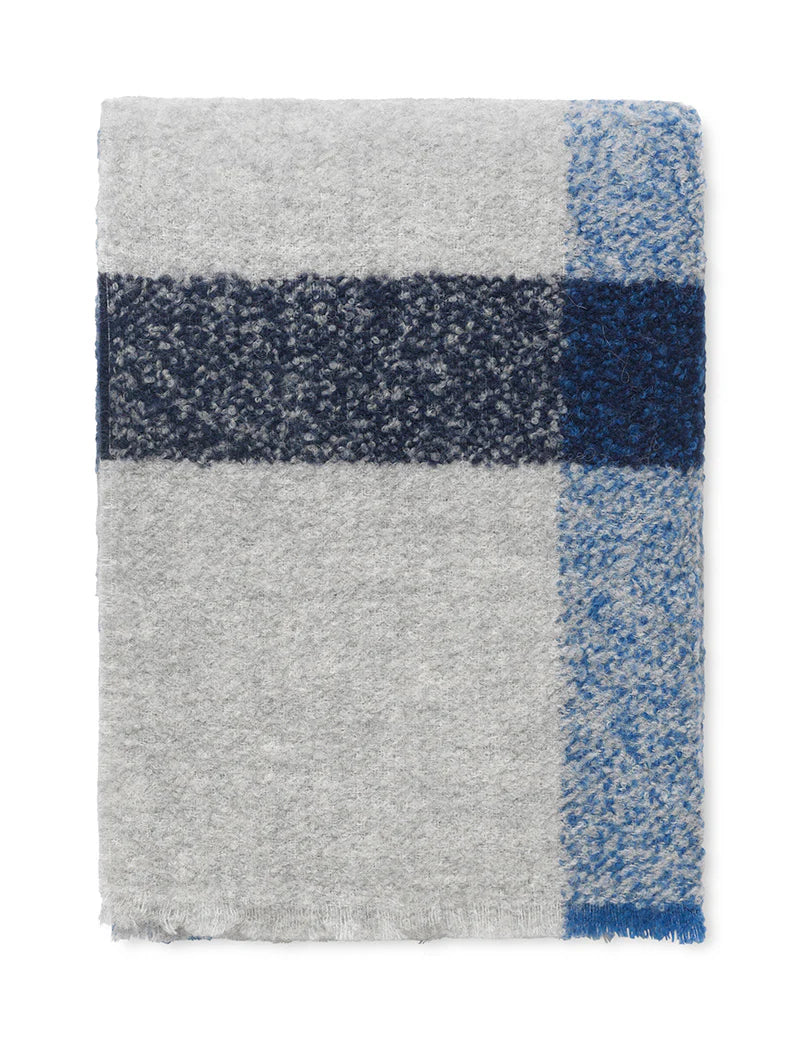 The Elvang Denmark Lava Throw - Cobalt Blue is a folded light gray alpaca wool throw with a wide dark blue stripe intersected by a lighter blue vertical stripe, featuring a textured, heathered pattern and classic Scandinavian design.