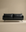 The SOBU Cherry Sofa | Leather, a modern black 3-seater with slim arms and metal legs, brings Danish-inspired style to any living space, shown centered against a plain beige background.