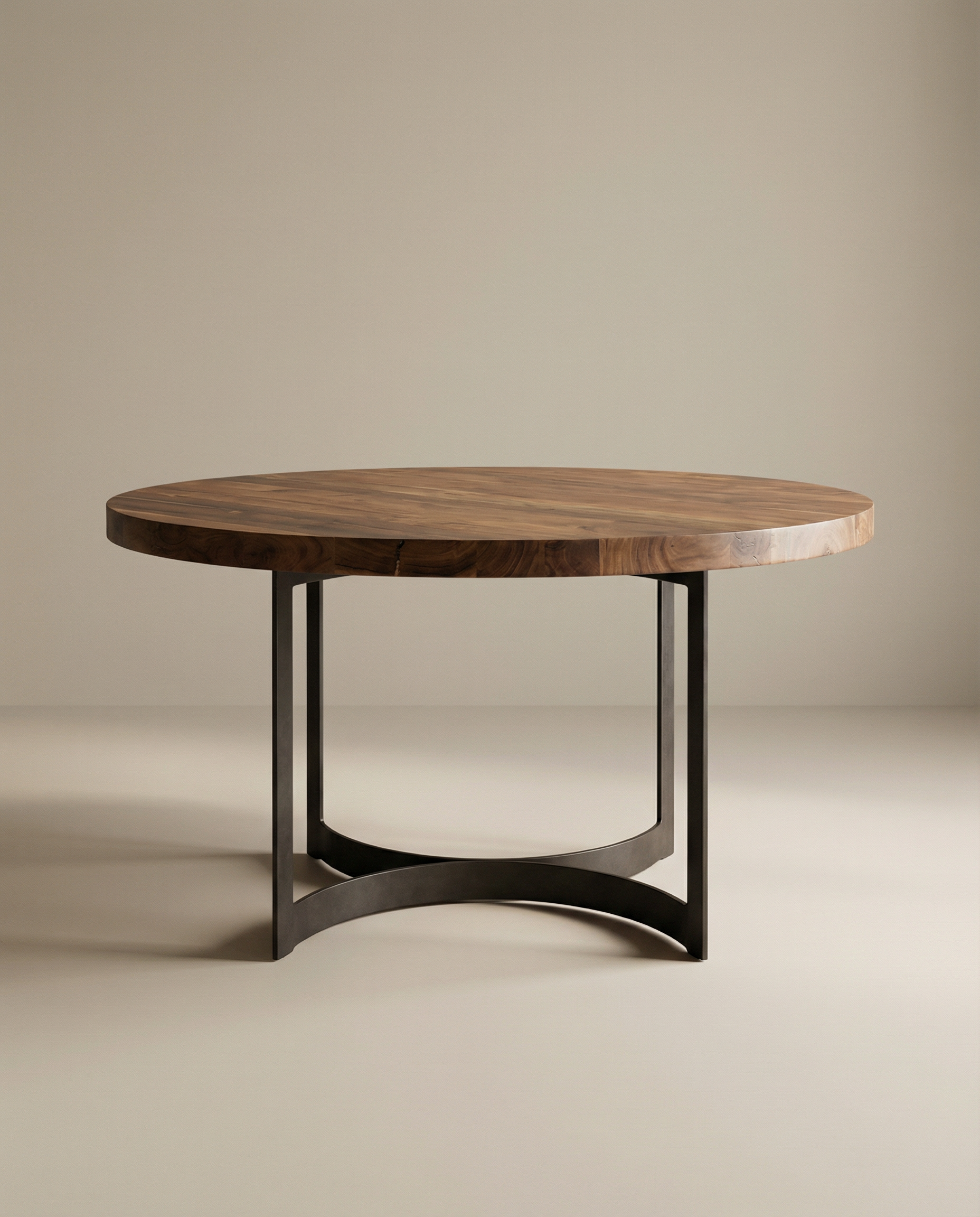 The SOBU Leviathan Round Dining Table features a thick acacia wood top with a natural finish and sleek metal legs, showcased against a plain beige background.