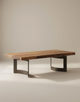 The Moes Leviathan Live Edge Coffee Table showcases a thick, rectangular solid acacia top with natural edges and a sleek black metal base, elegantly displayed against a simple light background.