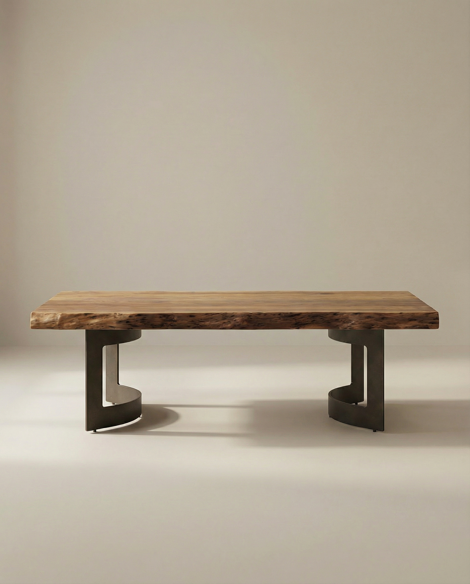 The Moes Leviathan Live Edge Coffee Table features a thick acacia wood slab top with natural edges and two dark, curved geometric metal legs, set against a plain beige background.