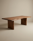 The SOBU Leviathan Live Edge Dining Table features a large, rectangular solid acacia top with natural live edges and two wide wooden legs, shown against a plain, neutral background.
