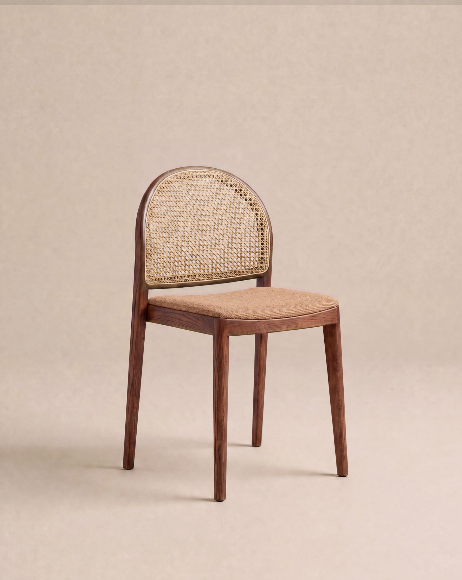 The Luk Dining Chair | Fabric Seat by Wooden Stories features a simple, minimalist design with a woven cane weave rattan backrest, and sits on a beige background, evoking the timeless style of the Danish Collection.