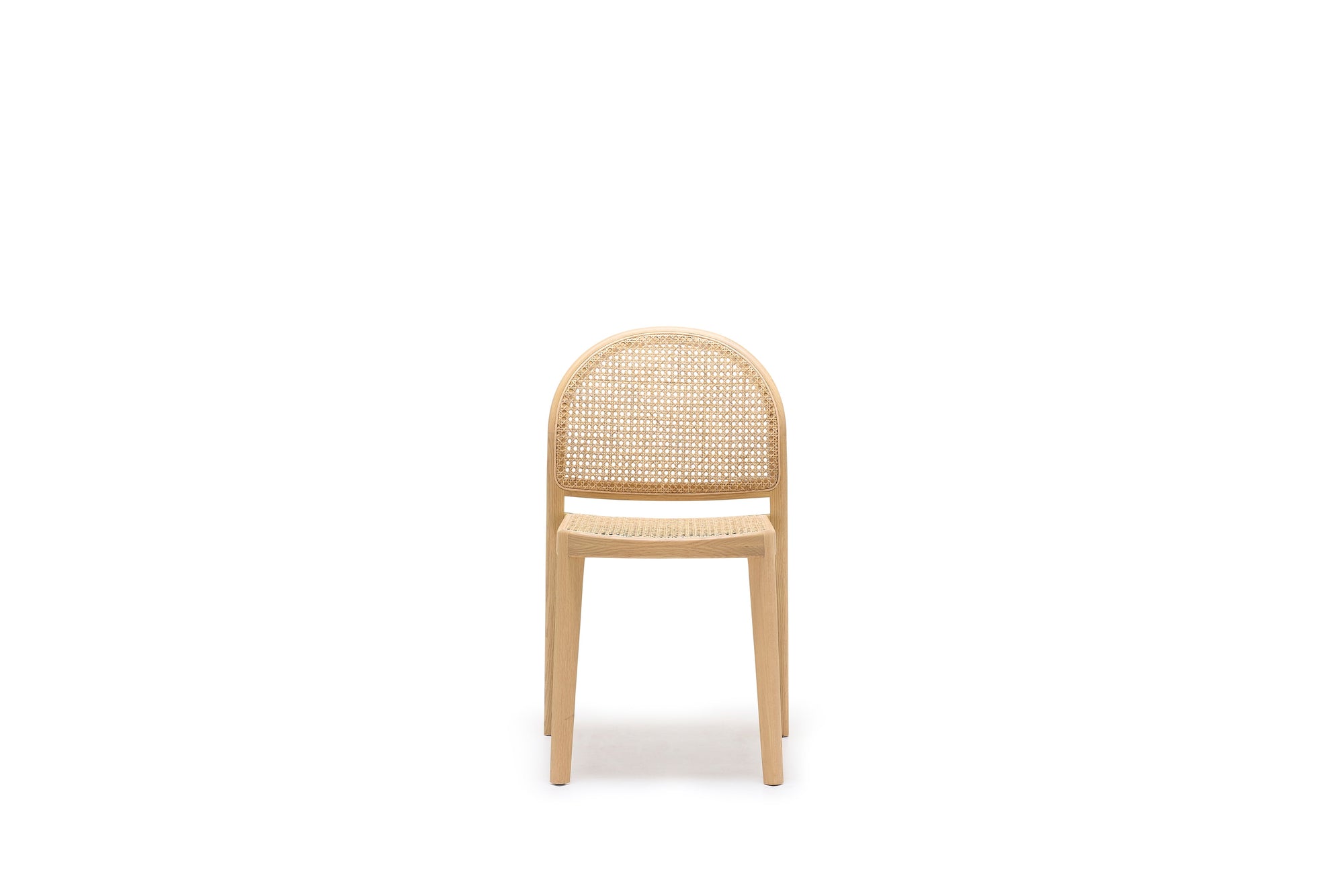 The Wooden Stories Luk Dining Chair features a light wood frame, rounded backrest, and elegant cane weave rattan seat and back, photographed on a plain white background—ideal for contract grade spaces.