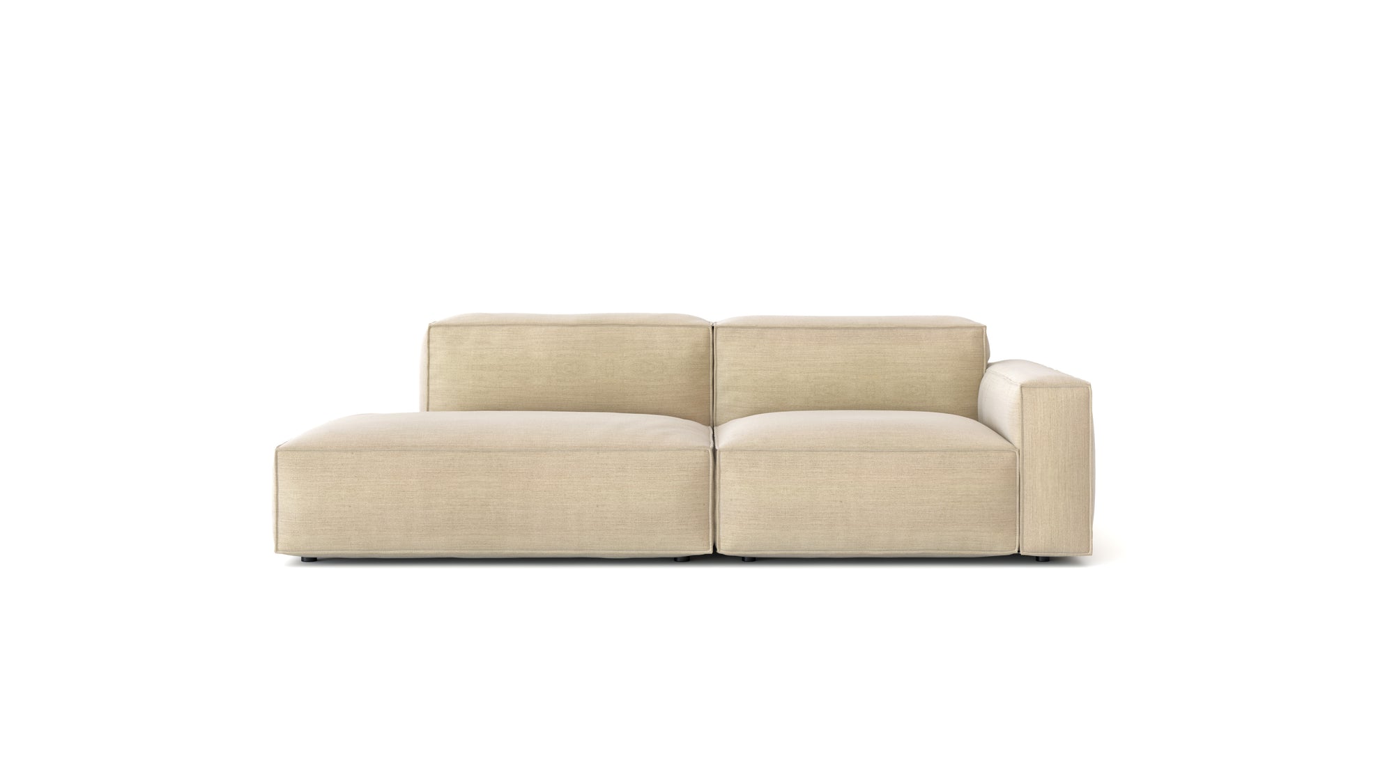 The Baker Modular Sofa | Fabric • M1 by Wooden Stories is a modern beige sofa with a low profile, wide cushions, right-side armrest, and minimalist design, displayed against a plain white background.