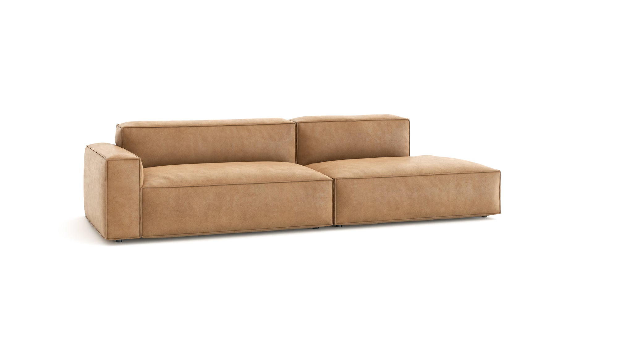 The Wooden Stories Baker Modular Sofa | Leather • M2 is a modern tan leather sofa with wide armrests and a right-side chaise lounge, shown against a plain white background.