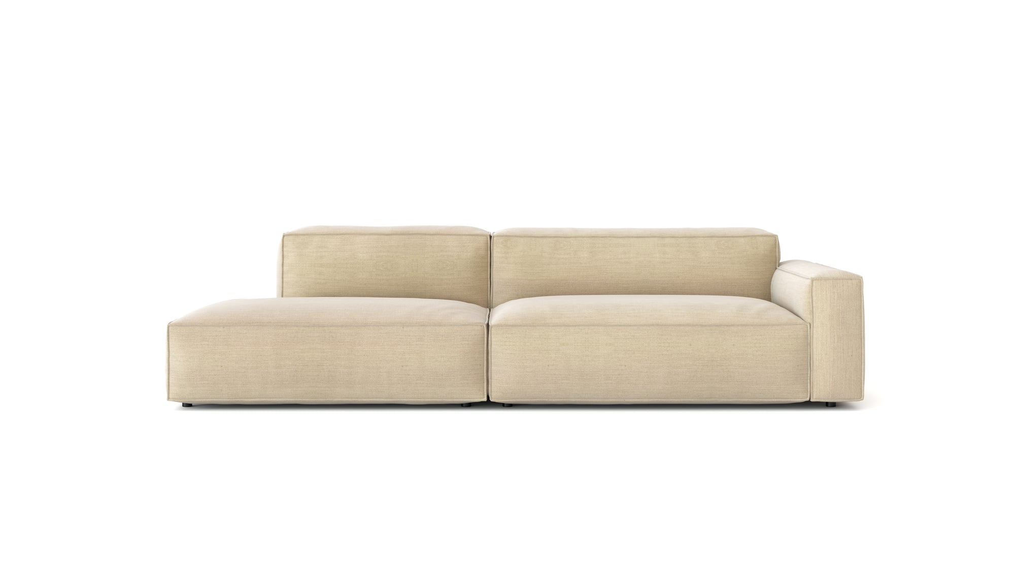 The Baker Modular Sofa | Fabric • M2 by Wooden Stories is a modern, light beige sofa with clean lines, low backrests, a left chaise lounge, and right armrest, displayed on a plain white background.