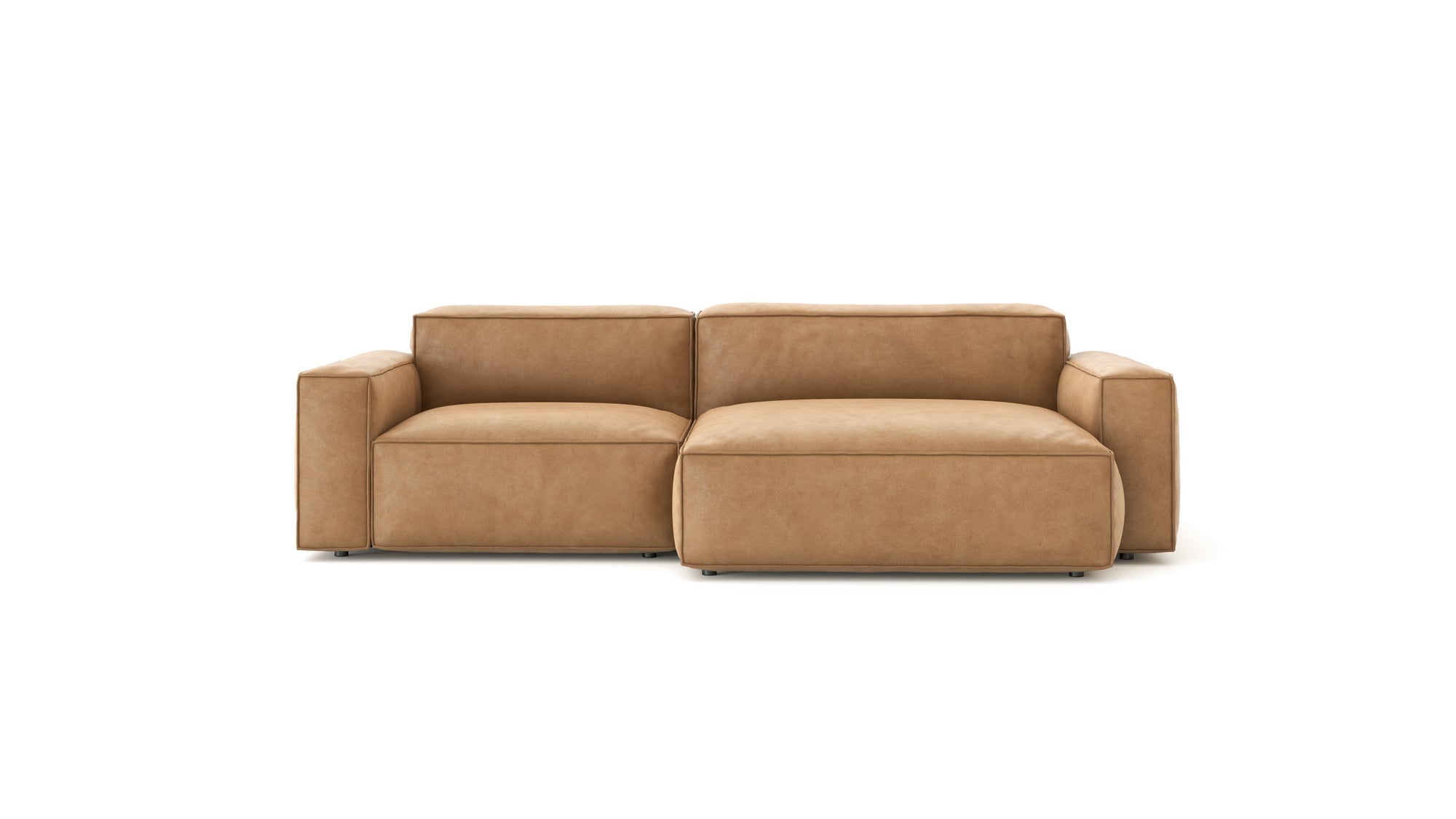 The Baker Modular Sofa | Leather • M3 by Wooden Stories is a modern tan leather sofa with wide arms and a right-side chaise, ideal for contemporary spaces and shown against a plain white background.