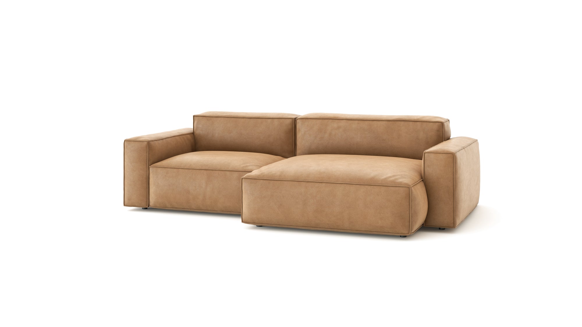 The Baker Modular Sofa | Leather • M3 by Wooden Stories is a modern tan leather sectional with wide armrests and a right-side chaise, shown on a plain white background—an ideal fit for contemporary spaces.