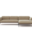 The Department Modular Sofa | Fabric • M4 by Wooden Stories is a modern beige sectional with a right-side chaise, slim black legs, and a low backrest, inspired by Danish collections and shown on a white background.