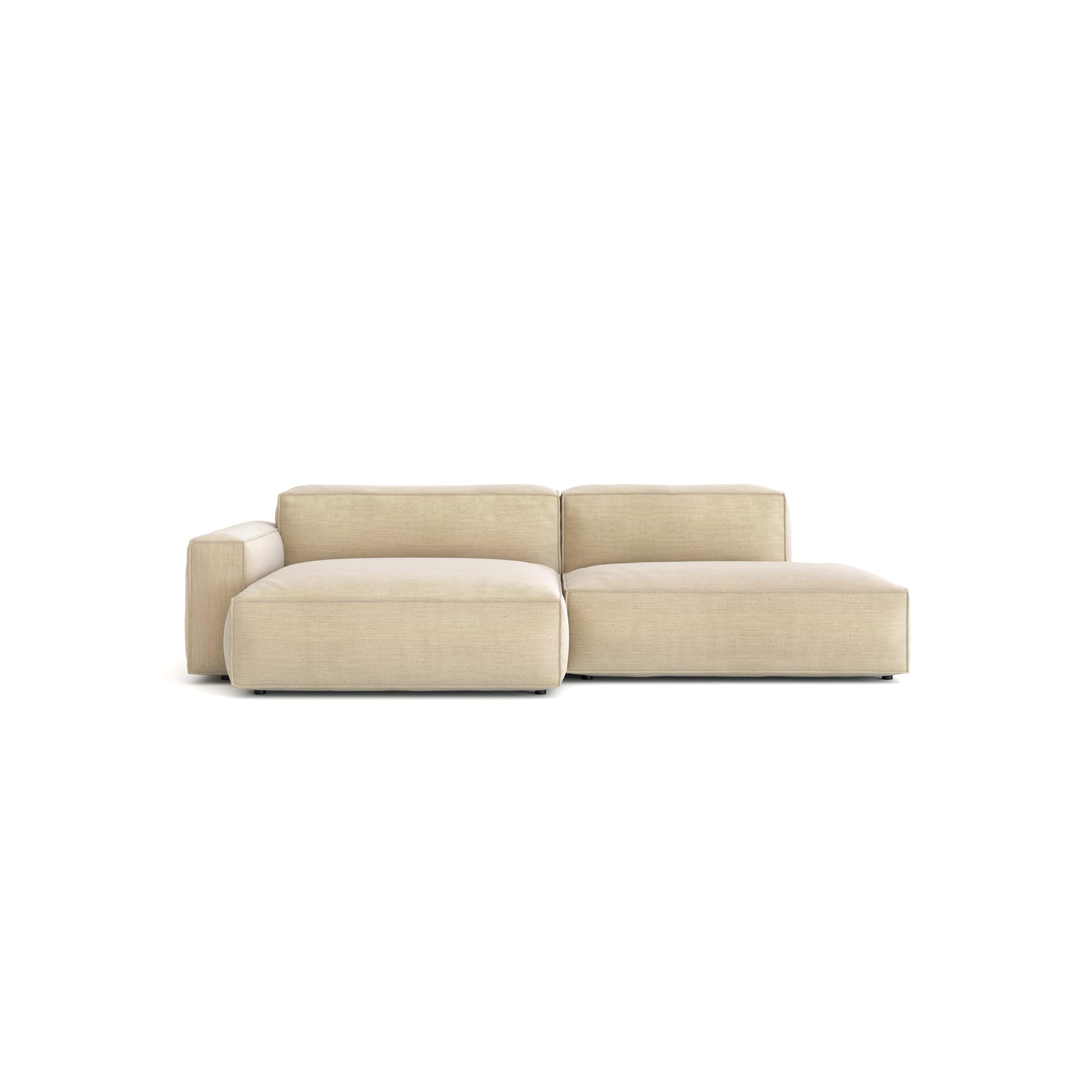 The Baker Modular Sofa | Fabric • M4 by Wooden Stories is a modern, light beige sofa with wide seats, a low backrest, and a left armrest. Its clean, minimal Danish-inspired design stands out against a white background.